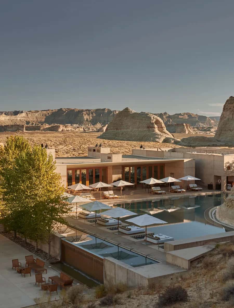 Amangiri desert resort pool with umbrellas, daybeds and sandstone rock formations, Utah