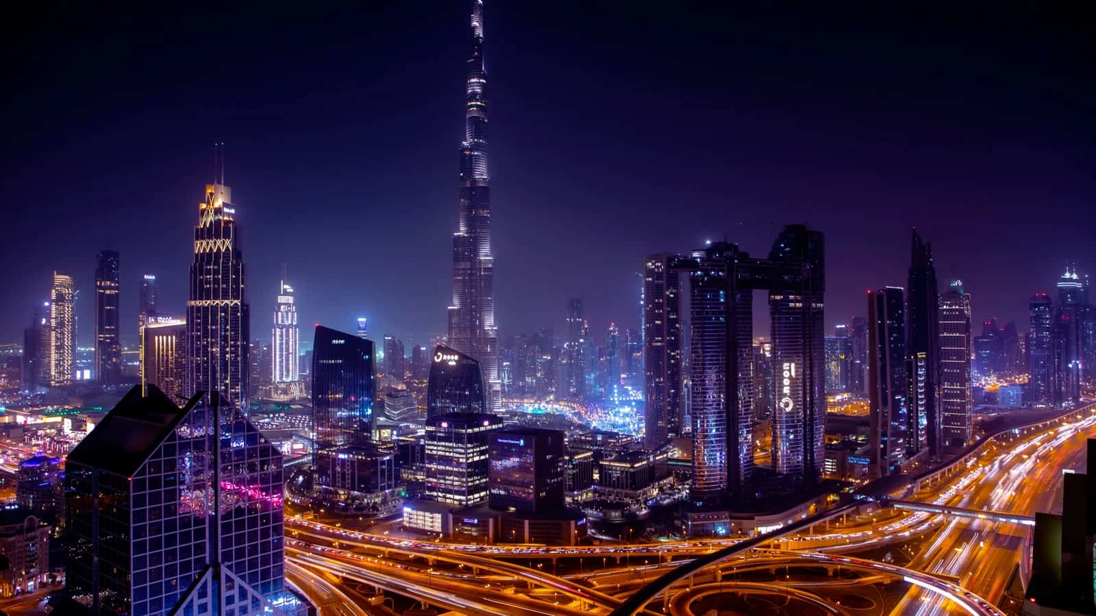 Burj Khalifa and Dubai city skyline at night — luxury dining region